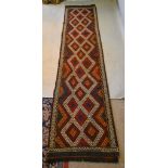 A North West Persian Woollen Runner with an all over design upon a red blue and cream ground