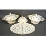 A pair of Meissen porcelain tureens with covers each decorated with foliate sprigs and highlighted