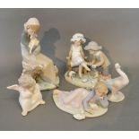 A Lladro Porcelain Group in the form of Two Children together with four other similar Lladro