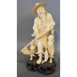 A 19th Century Japanese Ivory Okimono in the form of a Fisherman with Net and two Children upon a