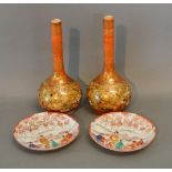 A Pair of Kutani Bottleneck Vases together with a pair of similar saucers