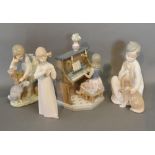 A Lladro Porcelain Model of a Girl Playing a Piano, together with three other similar Lladro