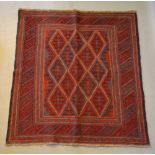 A North West Persian Woollen Rug with an all over design upon a blue and red ground within