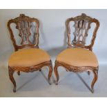 A Pair of 19th Century French Side Chairs, each with a carved pierced back above a drop in seat