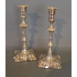A Pair of George III Style Silver Candlesticks with knopped stems and shaped bases, London 1915,