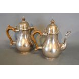A Queen Anne Style Silver Coffee Pot with shaped handle together with a matching hot water jug,