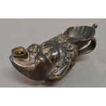 A Patinated Bronze Oil Lamp of Mask Head Form with Shaped Handle, 13 cms long