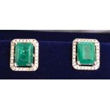 A Pair of 18ct. White Gold Square Cut Emerald and Diamond Cluster Earrings, emeralds approximately