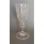 A 19th Century Wine Glass with foliate engraved decoration and with tapering knopped stem, 21 cms