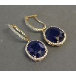 A Pair of 18ct. Yellow Gold Treated Sapphire Drop Earrings with Diamond Halo Surrounds,