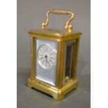 A French Brass Cased Carriage Clock, the silvered and enamel dial with Roman and Arabic numerals and