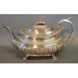 A George III Silver Teapot of Half Lobed Form with shaped handle and four paw feet, Exeter 1818,