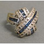 An 18ct. White Gold Diamond and Sapphire Ring set with Tiered Bands of Sapphires and Diamonds