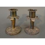 A Pair of White Metal Dwarf Candlesticks