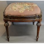 A 19th Century French Stool with a tapestry upholstered drop in seat raised upon turned tapering