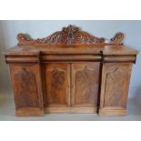 A William IV Mahogany Inverted Sideboard with a carved scroll back above three concealed frieze