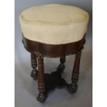 A French Mahogany Stool with a Shaped Padded Seat raised upon tapering legs with under tier