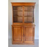 A 19th Century Mahogany Bookcase, the moulded cornice above two glazed doors enclosing shelves,