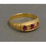 An 18ct. Yellow Gold Three Stone Ruby Ring