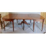 A Regency Mahogany Dining Table comprising a pair of ends with ring turned tapering legs, brass caps