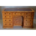 A 19th Century Satinwood Kneehole Desk, the leather inset moulded top above nine drawers with knob