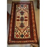 A North West Persian Woollen Rug with an all over design upon a red, blue and cream ground within