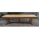 A Blonde Oak Large Refectory Style Dining Table, the plank top above a plain frieze raised upon five