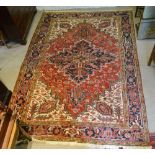 A North West Persian Heriz Carpet with a large central medallion within an all over design upon a