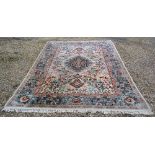 A North West Persian Woollen Carpet with a Central Medallion within an All Over Design depicting