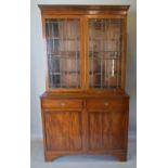 A 19th Century Mahogany Bookcase, the moulded cornice above two glazed doors enclosing shelves,