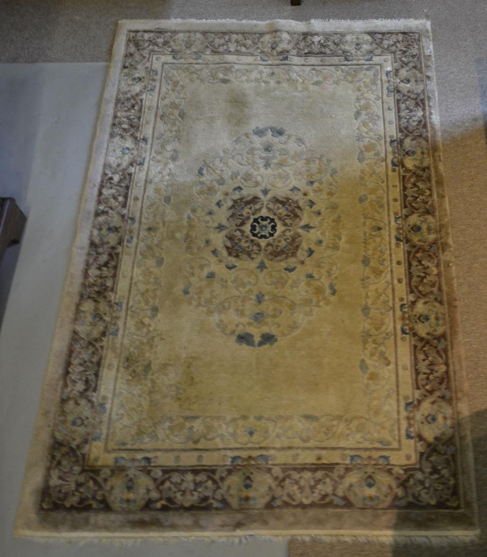 A Chinese Silk Work Rug with a central medallion within multiple borders, 185 x 123 cms