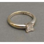 An 18ct. White Gold Diamond Set Ring with four diamonds in the form of a square