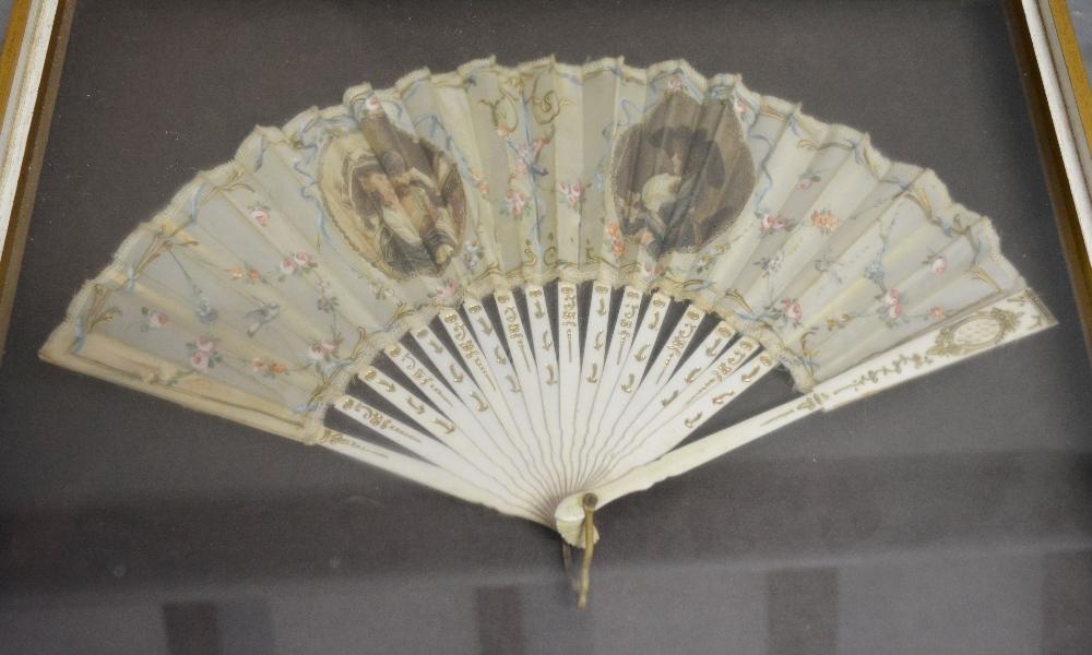 An Early 19th Century Ivory and Silk Fan, decorated with classical figures amongst foliage and