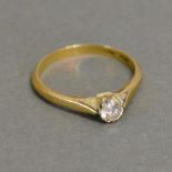 An 18ct. Gold and Platinum Solitaire Diamond Ring