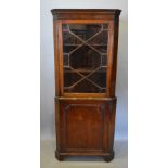 A Mahogany Standing Corner Cupboard, the moulded top above an astragal glazed door with cupboard