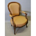 A Victorian Walnut Drawing Room Armchair with an upholstered back and seat with scroll arms,