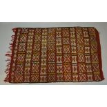 A Turkish Woollen Rug with an all over design upon a red ground, 147 x 94 cms