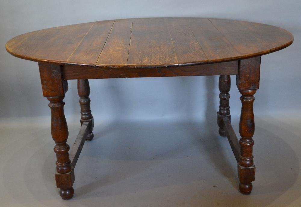 An 18th Century and Later Oval Dining Table, the oval plank top above baluster turned legs with