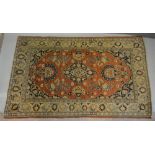 A North West Persian Woollen Rug with a central medallion within an all over design upon a red, blue