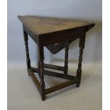 A 19th Century Oak Drop Flap Table of Triangular Form with turned legs and stretchers