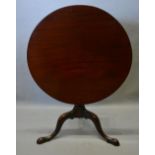 A George III Mahogany Tilt Top Table, the circular top above a wrythen turned centre column