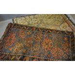 A North West Persian Woollen Rug with an all over design upon a blue, red and cream ground