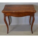 A 19th Century French Mahogany Serpentine Card Table, the hinged top above a shaped frieze upon