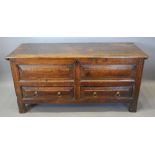 A Late 17th Early 18th Century Oak Mule Chest, the hinged top above two moulded drawers with