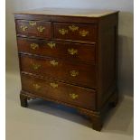 A George III Oak Chest, the moulded top above two short and three long drawers with brass handles