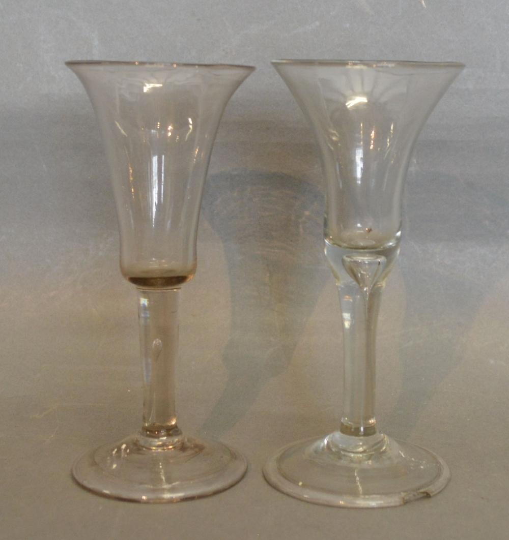 An 18th Century Drinking Glass, the bell shaped bowl above a teardrop stem and folded conical