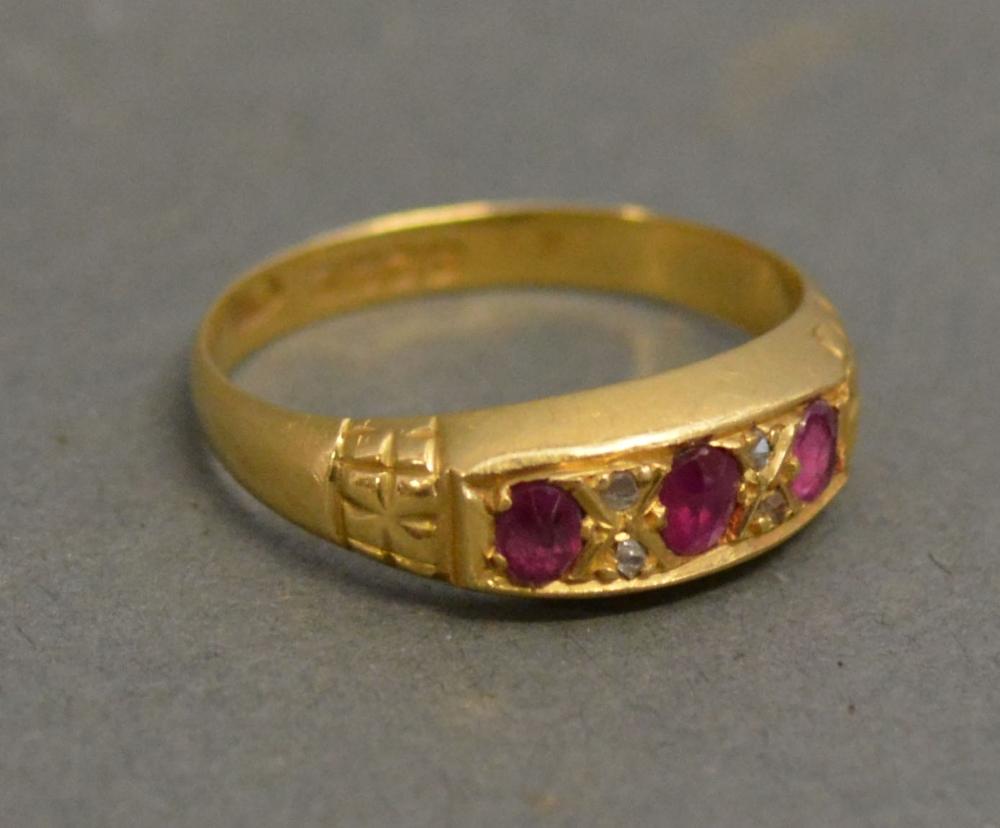 An 18ct. Yellow Gold Three Stone Ruby Ring