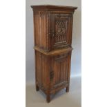 A Gothic Revival Oak Side Cabinet with a Gothic Tracery Panel Door above a similar Linen Fold Door