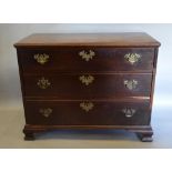 A George III Mahogany Chest of three long drawers with brass handles and escutcheons raised upon