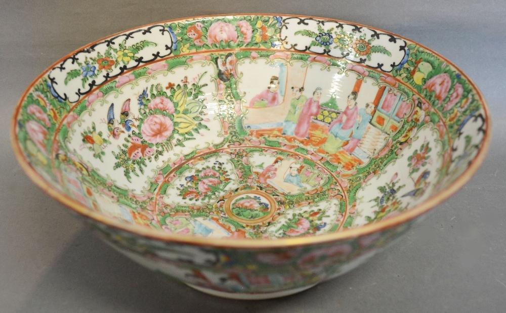 A Canton Bowl decorated in coloured enamels with Figures within Landscapes and highlighted with